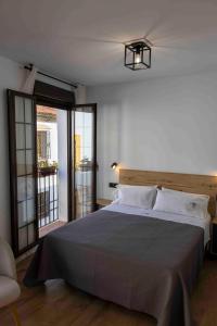 Ένα ή περισσότερα κρεβάτια σε δωμάτιο στο MiRa San Basilio