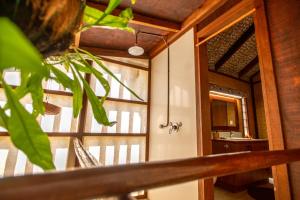 a room with a window and a bathroom with a sink at Rarotonga Beach Bungalows in Rarotonga
