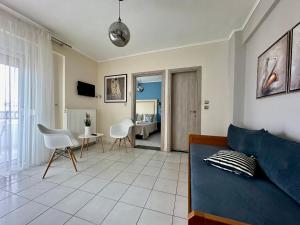 a living room with a couch and a table and chairs at Assamaris in Asprovalta