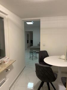 a dining room with a table and two chairs at Moderne 2 Zimmer Wohnung mit Vollausstattung in Ketsch