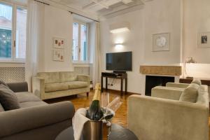 a living room with couches and a tv and a fireplace at Orsoline Boutique Apartments - Best position in Rome in Rome