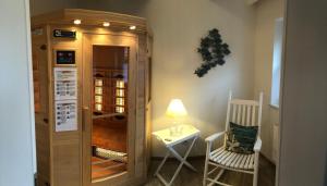 a room with a wine cabinet and a table and a chair at Dat Onnens Hus - Burhave 16 in Butjadingen