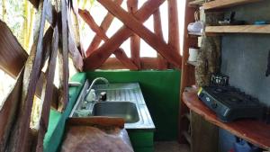 a kitchen with a sink and a stove at EL ALTO DE CISNEROS " para caminantes" in Cisneros