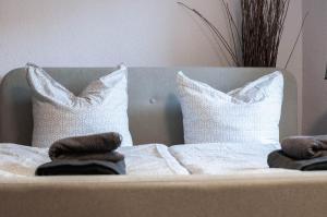a bed with two pillows and towels on it at Landdomiziel in Damerow +10 photos