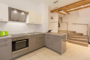 a kitchen with a sink and a stove top oven at Am Schlosspark in Bad Harzburg +5 photos