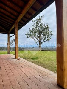 an empty porch with a tree in the background at Villa Federica "UnaNotteaCasaMia" in Sacrofano