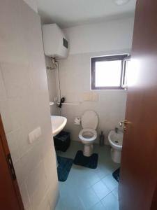 a small bathroom with a toilet and a sink at Desiree's Rooms - n 2 camere con bagno privato e balcone in Trecchina +13 photos