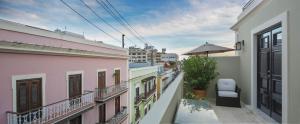 a balcony of a building with an umbrella at Decanter Hotel in San Juan