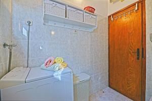 a bathroom with a washing machine and a washer at House Viki in Postira +16 photos