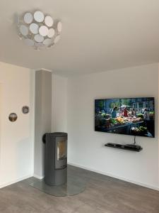 a living room with a flat screen tv on a wall at "Ostsee Ankerplatz" in Markgrafenheide +16 photos