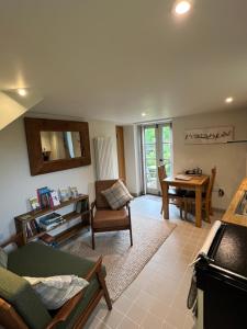 a living room with a couch and a table at The Old Stable at Manor House, Middleton in Middleton