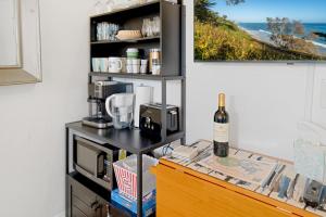 a kitchen with a counter with a bottle of wine at Danyas Room in Summerland