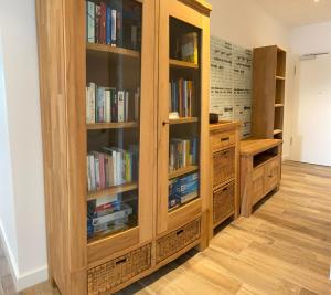 a library with wooden book cabinets filled with books at Port Marina "Schlagseite" in Bremerhaven +15 photos