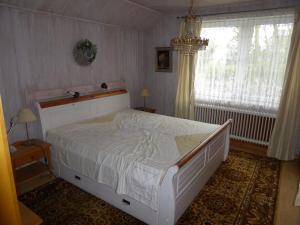 a bedroom with a white bed and a window at Landhaus an der Hase in Herzlake