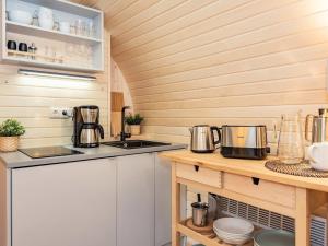 a kitchen with a counter with two coffee makers on it at Tinyhouse 2 in Heringsdorf