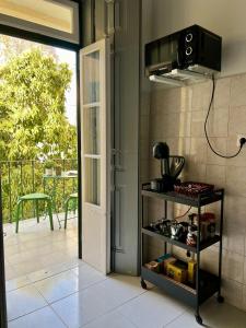 a kitchen with a door open to a balcony at Spacious T4 Central Apartment with Iconic Tram 28 View in Lisbon