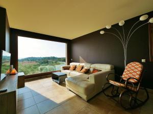 a living room with a couch and a large window at Ca la Moni Gualta in Gualta