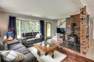 a living room with a couch and a fireplace at Enchanting Waterfront Sorrento Home with Deck! in Sorrento