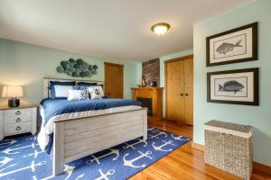 a bedroom with a bed and a blue rug at Enchanting Waterfront Sorrento Home with Deck! in Sorrento