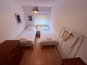 a small room with two beds and a window at Apartament Złota Woda in Głuszyca