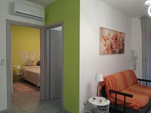 a living room with a couch and a bed at Appartamento Mare Verde Bambù in Martinsicuro +16 photos