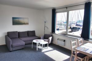 a living room with a couch and a table and a window at Alte Segelschule in Lübeck