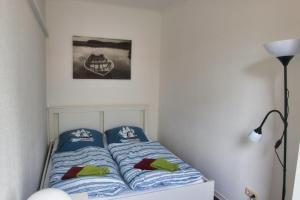a bedroom with a bed with blue and white sheets at Alte Segelschule in Lübeck