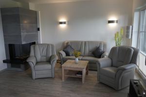 a living room with two couches and a coffee table at Nordlicht II in Trent
