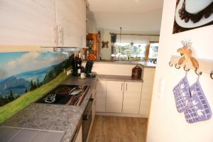 a kitchen with white cabinets and a counter top at Alpenspatzl in Reit im Winkl