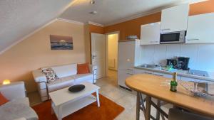 a living room with a couch and a table at Seenebel in Prerow