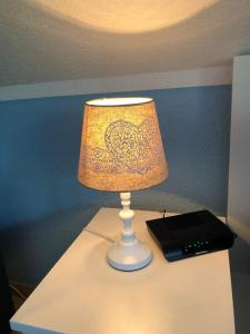 a lamp sitting on top of a table with a book at Seenebel in Prerow