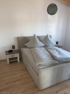 a bed with pillows on it in a bedroom at Im Tal der Loreley in Lierschied +10 photos