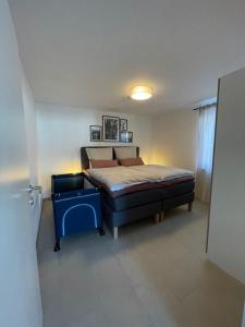 a bedroom with a bed and a blue table at Haus Malea in Todtnauberg