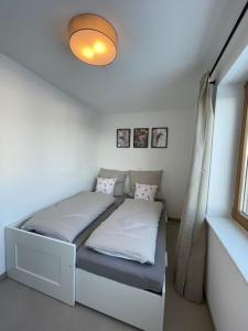 a small bed in a room with a window at Haus Malea in Todtnauberg