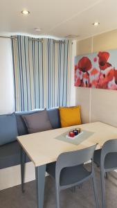 a living room with a table and a couch at Campingland Ostsee - Mobilheim 016Weitsicht in Schashagen