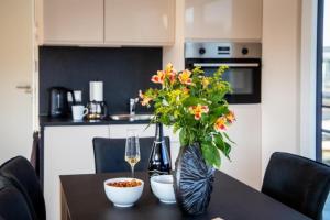 a dining room table with a vase of flowers on it at Hausboot Bahama Mama in Klitten