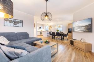 a living room with a couch and a table at Ferienhof Marquardt Bungalow 5 in Fehmarn