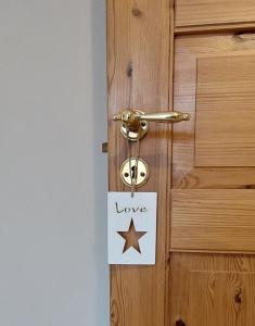 a door with a sign that says love and a star at "SüdWest" Ferienwohnung in Prerow +6 photos