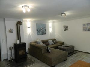 a living room with a couch and a stove at Helle Komfortwohnung in Möhnesee