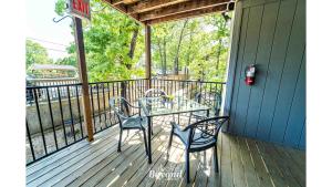 a table and chairs sitting on a deck at Peaceful & No Stairs Minutes to Silver Dollar City in Reeds Spring
