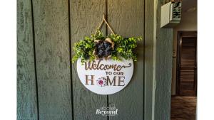 a welcome to our home sign hanging on a wall at Peaceful & No Stairs Minutes to Silver Dollar City in Reeds Spring +61 photos