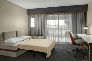 a hotel room with a bed and a desk at Courtyard by Marriott Kokomo in Kokomo +27 photos