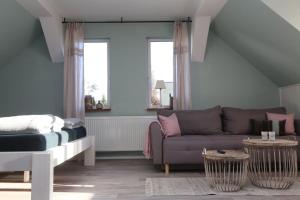 a living room with a couch and a bed at BLUMENSTIL Ferienwohnungen 2 in Bad Salzungen