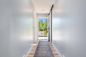 an empty hallway with a rug in a house at Platte River Play Lovely 2bdr Barnhouse 2852 in Beulah +88 photos