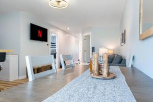 a white living room with a couch and a table at Platte River Play Lovely 2bdr Barnhouse 2852 in Beulah