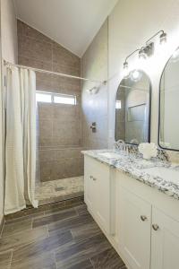 un bagno con doccia, lavandino e specchio di Stylish Escape 3BDRM with fireplace a El Paso