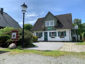 a house with a street light in front of it at Ferienhaus Schiffchen "An Deck" in Prerow