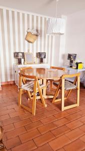 a dining room with a wooden table and chairs at Apartment in Vilamoura with pool in Quarteira