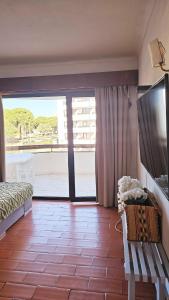 a living room with a view of a balcony at Apartment in Vilamoura with pool in Quarteira