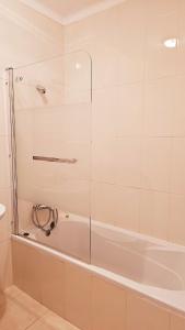 a bathroom with a shower and a tub at Apartment in Vilamoura with pool in Quarteira +8 photos